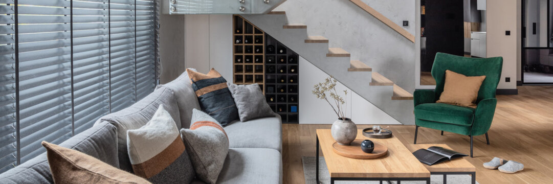 Modern Living Room Interior with Cozy Sofa, Stylish Armchair, and Contemporary Decor in a Home Setting
