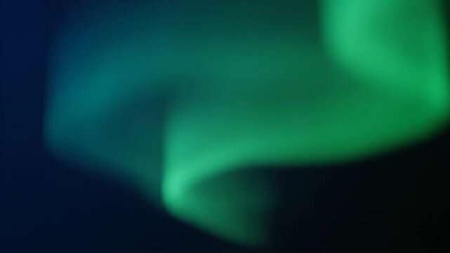 Abstract soft green aurora borealis glowing on dark blue night sky. Perfect for nature documentaries, cinematic backgrounds, ambient visuals
