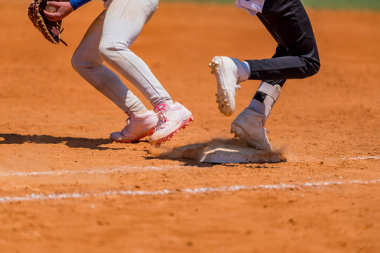 Racing Down the Line: Youth Baseball Player Hustles Toward First Base After a Big Hit