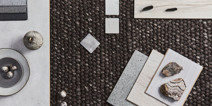 Stylish flat lay composition of architect moodboard with samples of building, brown textile and natural materials and personal accessories. Top view, template.