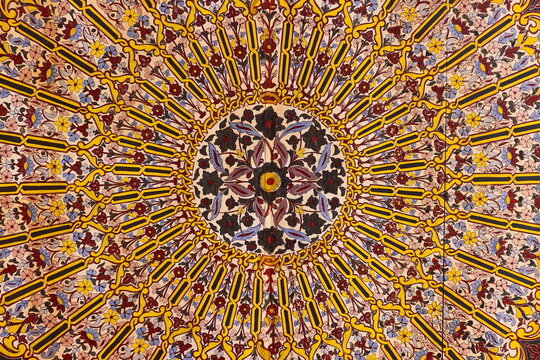 Circular, radial-shaped, colorful, flowery painted cedar wood ceiling of the gallery circling the Grand Courtyard, Bahia Palace. Marrakesh-Morocco-281