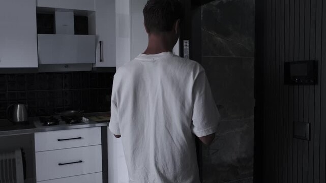 Psychological tension and hypervigilance concept with anxious man rushing into apartment, locking door and checking peephole for safety and protection