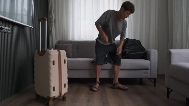 Fresh start in a new home. Man arriving at rented apartment, looking around and settling into a new chapter of life
