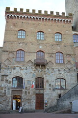 Obraz premium San Gimignano, Italy 03.04.2020: Town Hall (also known as the Palazzo del Popolo or Palazzo Nuovo del Podestà) and the Torre Grossa in San Gimignano