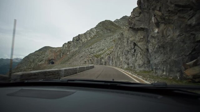 View of the Alpine mountain landscape from a car window. Mountain travel and tourism; European natural landscapes.
