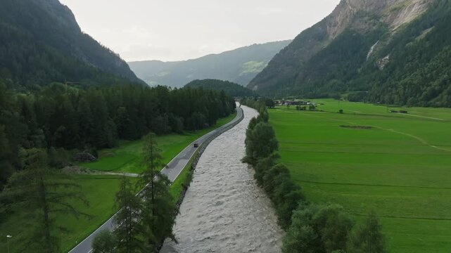 Scenic landscape of the fast flowing Otztaler Ache River in the Austrian Alps surrounded by mountain wilderness and natural beauty in Tyrol