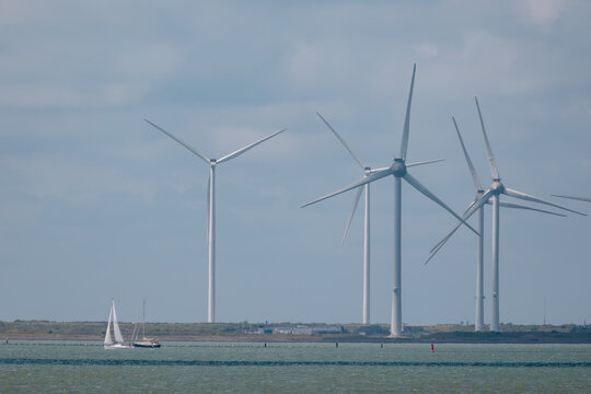 Wind power generation and sailing in Zeeland, Netherlands, symbolizing clean energy and sustainable living