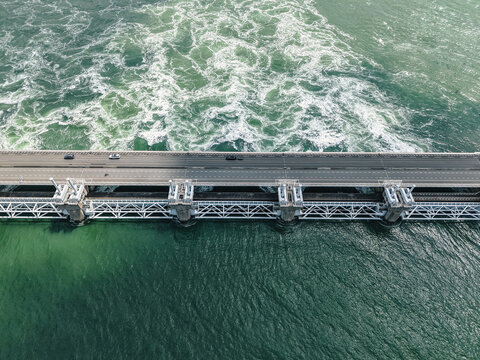 Oosterscheldekering, Delta Works flood barrier protecting the Netherlands with a highway above raging current, aerial view