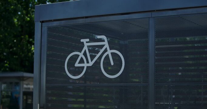 White bicycle icon printed on a glass panel at a public transport station