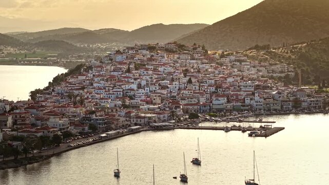 Aerial zoom out of Peninsula of Ermioni Port Town and Harbor at Sunset, Greece