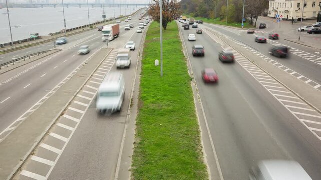Timelapse of headlights glowing on the highway during the day, headlights on the road, many cars