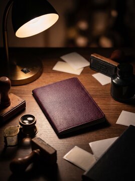 Burgundy leather booklet cover mockup on document desk