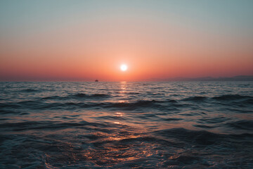Fototapeta premium Warm sunset over the sea capturing a peaceful summer vacation lifestyle
