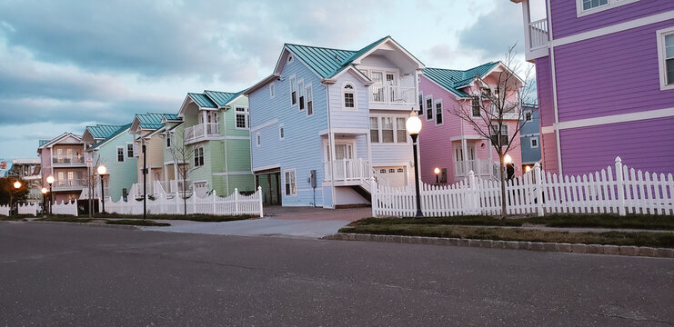 Row of vibrant pastel color houses along a coastal neighborhood street at dusk, Beach Haven, New Jersey