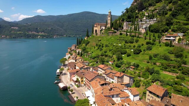 Cinematic Aerial Drone of Morcote Village Lake Lugano Switzerland Iconic Church Santa Maria del Sasso and Cascading Lakeside Houses Alpine Lake Panorama 4K Footage. most beautiful swiss villages