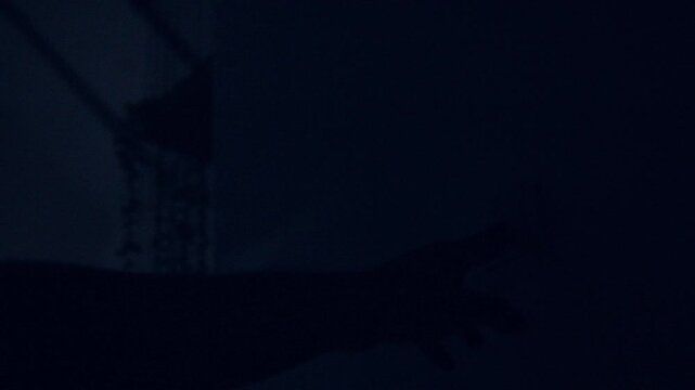 A wall light switch being turned off at night. Turn on room electric light wall switch pushing button