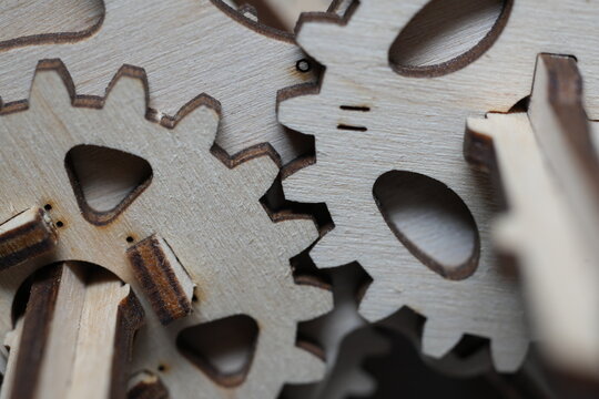 Macro shot of wooden gears interconnected in a mechanism.