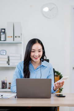 A businesswoman wearing headphones is a customer service representative.