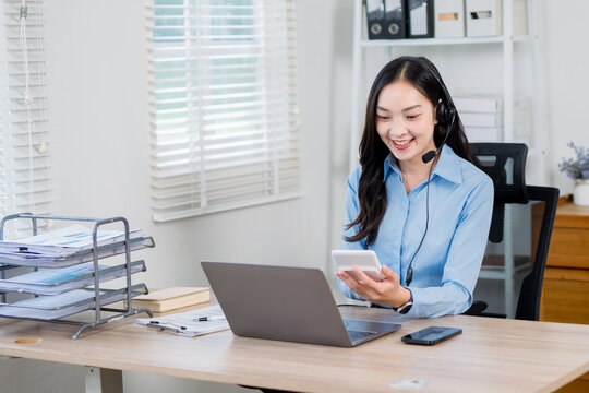 A businesswoman wearing headphones is a customer service representative.