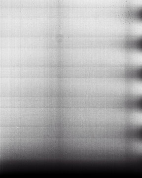 Blank grained film strip texture background with heavy grain, dust and light leak