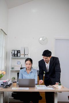  Accountants or business people working together on a project. Two female business colleagues are working on computers.