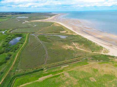 Wonderful aerial view of Brancaster beach seen on the North Norfolk, UK coastline. In the distance is Hunstanton, the sea is the Wash and on the left are salt marshes.