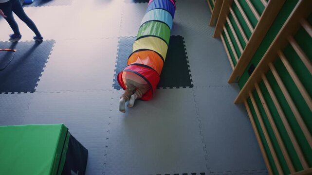 A young boy actively participates in kids fitness activities, navigating a vibrant soft play environment.