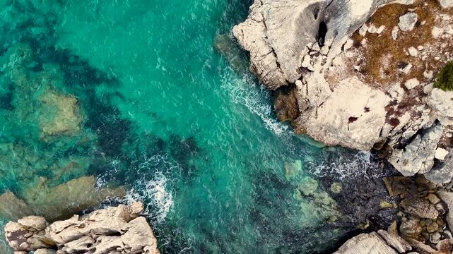 Aerial View of Turquoise Sea and Rocky Coastline with Lush Vegetation Near a Beautiful Beach. Holiday in Sardinia.