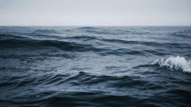 Ocean waves crashing against rocky coastline, dramatic coastal surf, turbulent sea