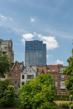 Brussels, Belgium. Historic townhouses with modern office tower skyline viewed from the Ixelles Ponds