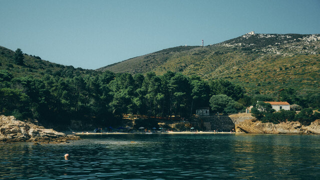 beach in sardinia with trees and mountains