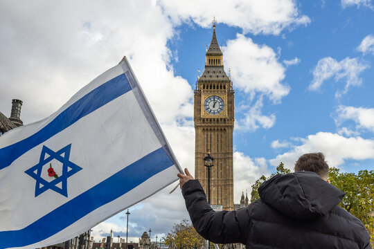 Person holding an Israeli flag near Big Ben in London