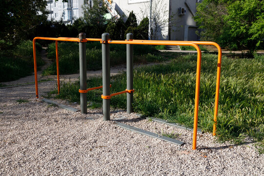 outdoor pull up bars and parallel bars at public fitness park for bodyweight training and strength exercise concept of street workout recreation community fitness and healthy lifestyle