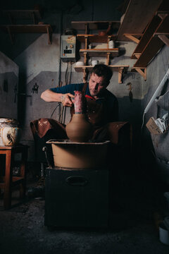 Potter Shaping Clay Vase on Wheel