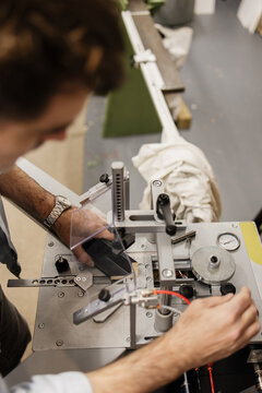 Artist working in workshop framing artwork