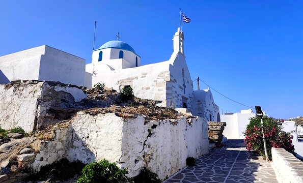 Exterior view of the historic blue-domed Church of Agios Konstantinos, gracefully nestled within the medieval Frankish Castle in Parikia, Paros Island, Cyclades, Greece. 