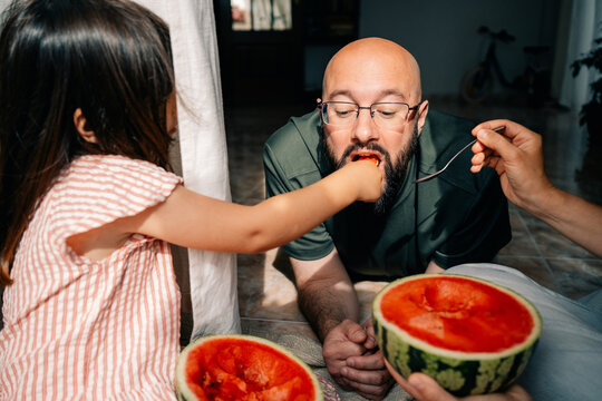 Father and Daughter Enjoy Watermelon Together at Home
