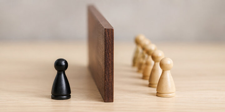 dividing wall between 2 different coloured 3d pawn figurines, social division