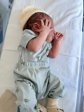 Newborn baby sleeping soundly resting in hospital crib