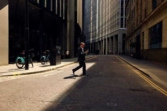 Businessman crosses the street in central London.