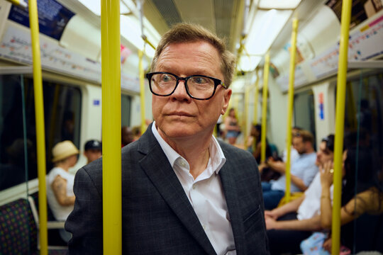 Elderly businessman commutes by subway train