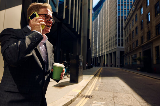 Businessman speaks on the phone in central London.