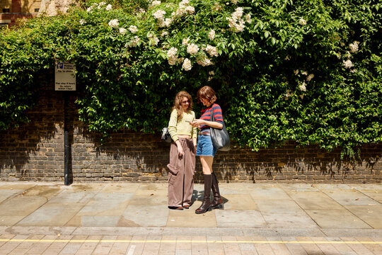 Friends Talking and Enjoying Time Together on a City Street