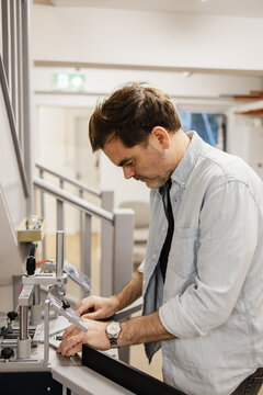 Male craftsman working in a framing studio workshop