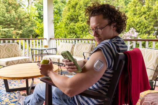 Smartphone App continuous glucose monitor Portrait outdoors 
