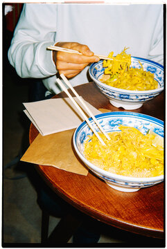 a man is about to eat pad thai with chopsticks, 35mm film