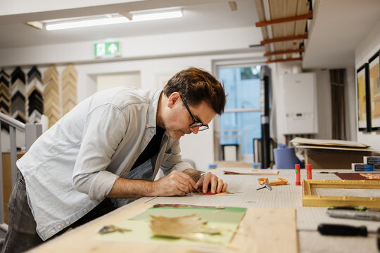 Artist crafting artwork in a professional workshop studio