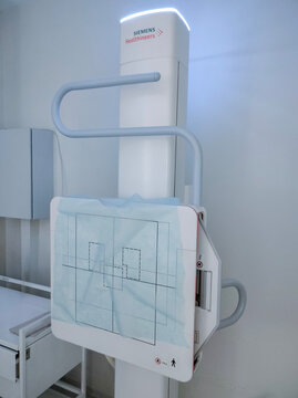 Kyiv, Ukraine - July 3, 2026: X-ray department in modern hospital. Radiology room with scan machine with empty bed. Technician adjusting an x-ray machine. Scanning chest, heart, lungs in modern clinic