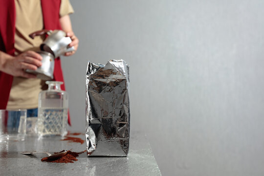 A barista prepares a coffee using a classic Italian moka pot.