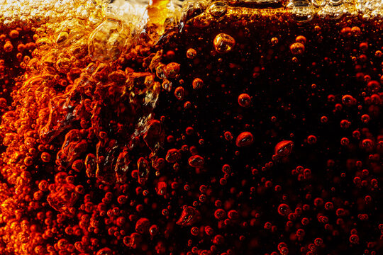 Carbonated drink is poured into a glass.